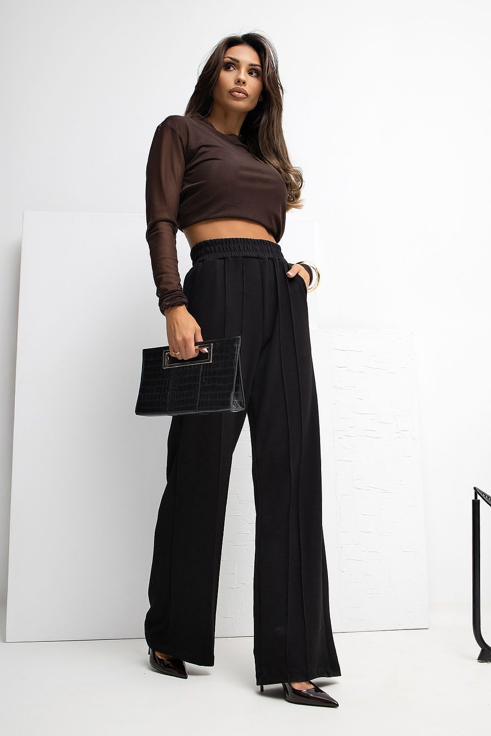 Rue Paris Women's High Waist Wide Leg Tracksuit Trousers in an elegant setting, exemplifying luxurious casual wear with practical side pockets and high-waisted design.