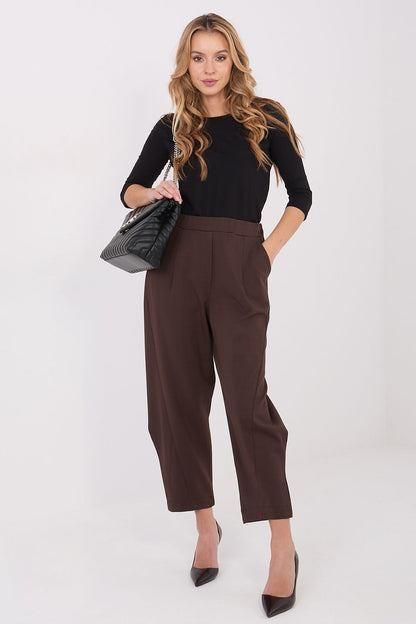 Model wearing Rue Paris elegant high-waisted trousers, demonstrating versatility and effortless chic style suitable for modern women.