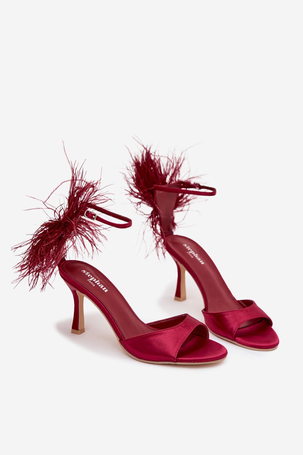 Close-up of Step in Style women's heel sandals featuring delicate textile material and stunning feather details, ideal for evening outings.