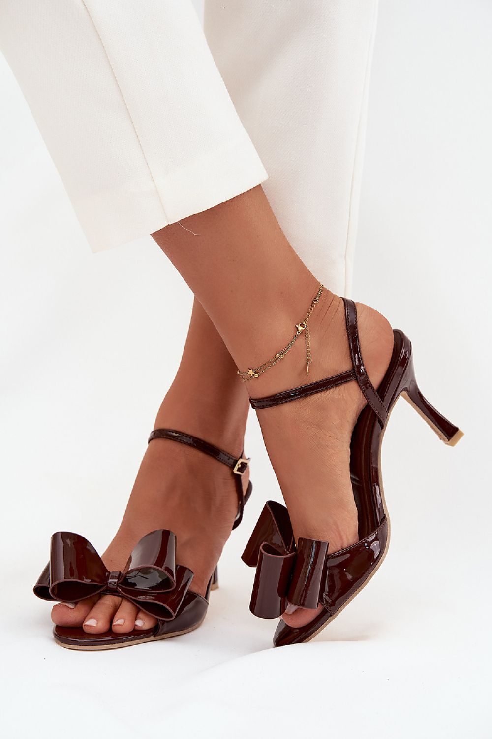 Close-up of adjustable strap sandals featuring eco leather and decorative bow, designed by Step in style for a refined feminine silhouette.