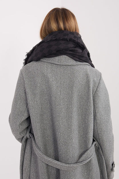 Stylish model wearing a large 148x148cm viscose-wool shawl by AT with fringes, demonstrating versatile ways to drape the elegant piece.