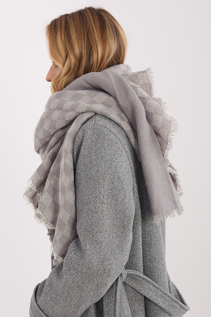 Versatile 148x148cm shawl styled as a scarf in a modern geometric pattern, designed by AT.