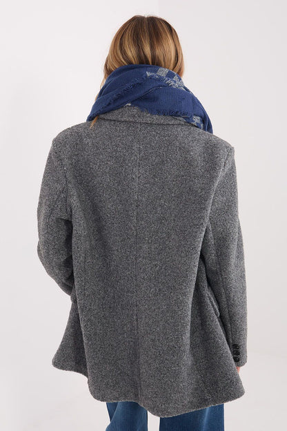 Elegant styling of a 148x148cm AT geometric shawl draped elegantly, highlighting its luxurious viscose and wool blend and fringed edges.