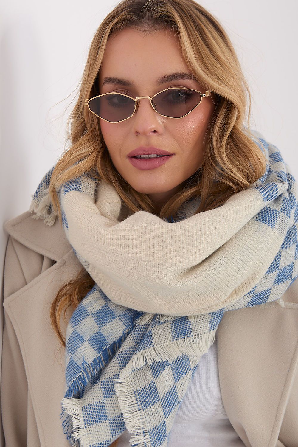 AT geometric shawl featuring delicate fringes, designed for versatile styling and added elegance.