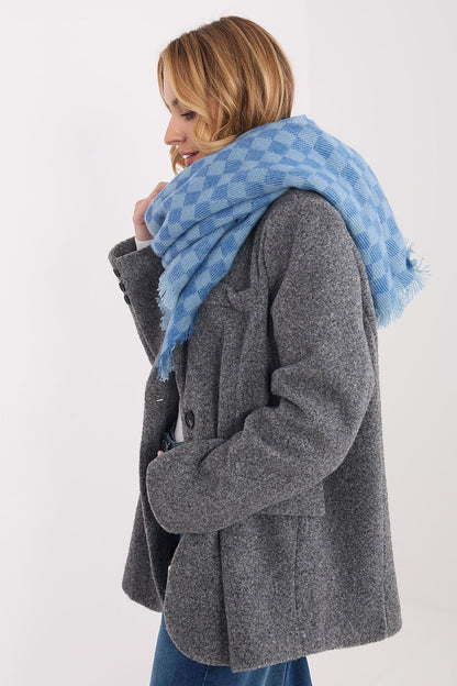 Close-up of the luxurious viscose-wool geometric shawl by AT, featuring delicate fringes and a modern pattern.