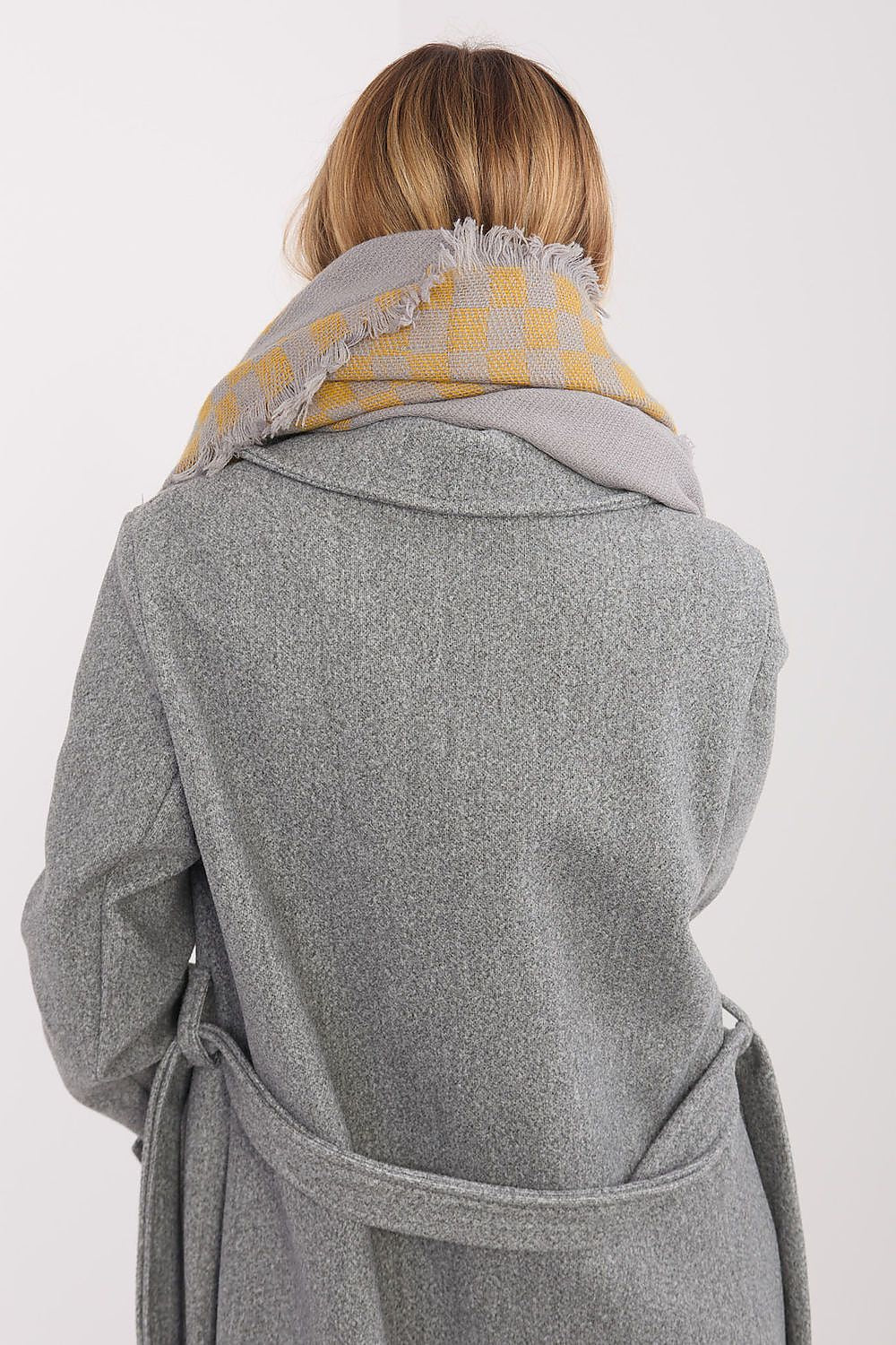 Fashionable representation of the AT luxurious viscose-wool shawl in geometric pattern, capturing its elegant drape and texture.