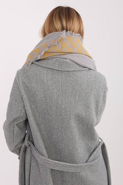 Fashionable representation of the AT luxurious viscose-wool shawl in geometric pattern, capturing its elegant drape and texture.