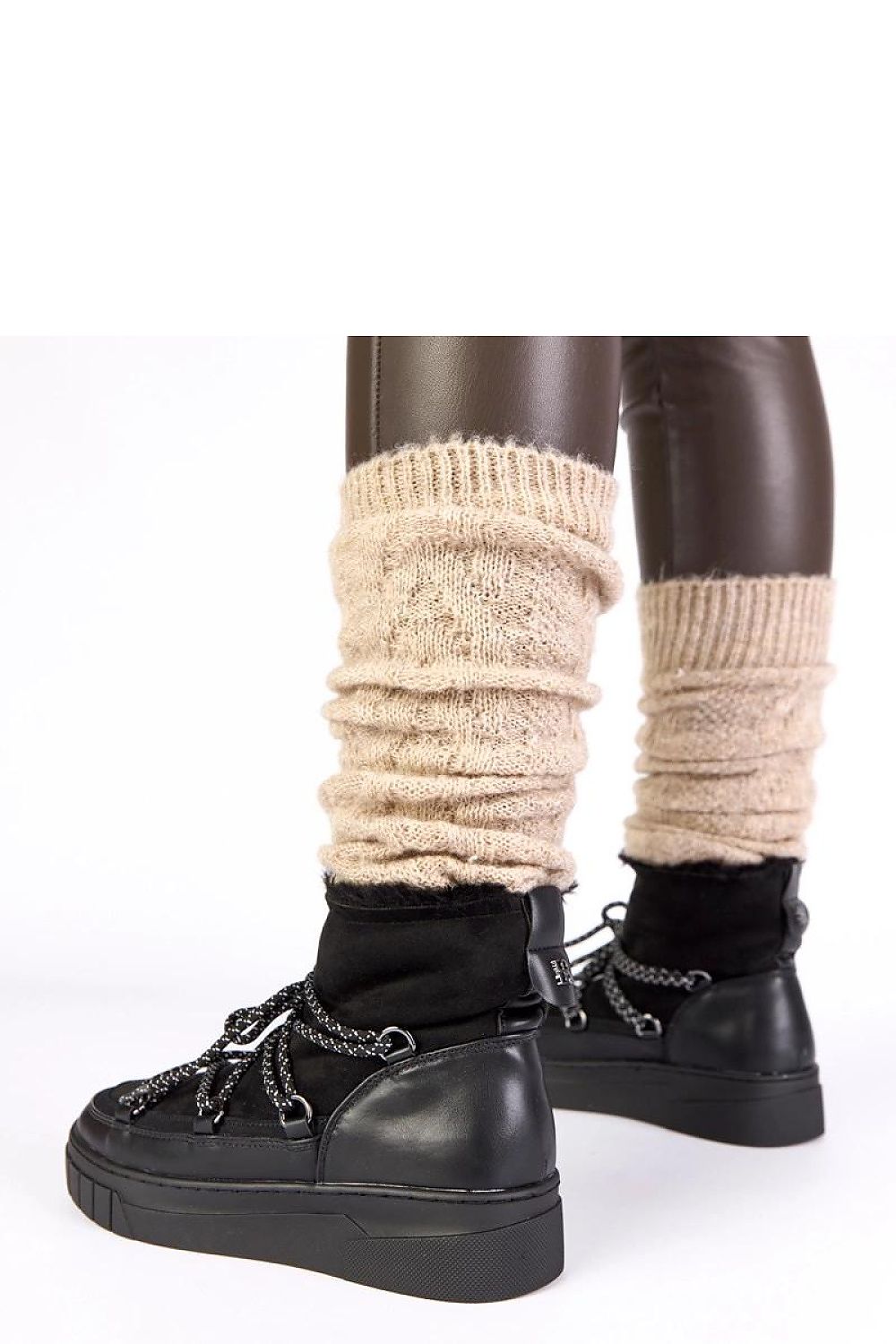 Solea Women's Esmee Black Lace-Up Snow Boots displayed on a frosty surface, highlighting their durable sole and classic black colour for winter chic.