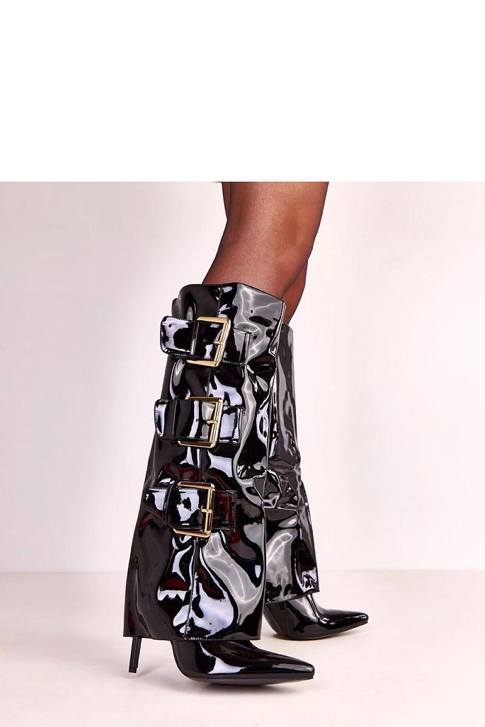 Close-up of the luxurious black patent surface of Solea's heeled boots, highlighting high-quality craftsmanship and shiny finish.