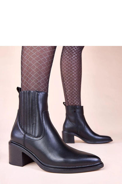 Elegant black ankle boots by Solea featuring a stylish block heel and elastic insert, perfect for fashion-forward women.