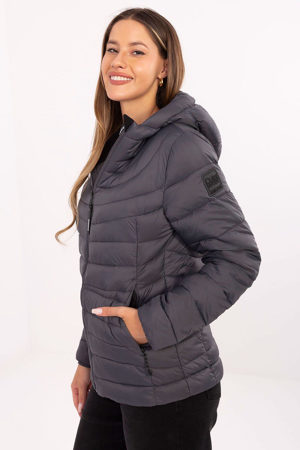 Elegant hooded women's transitional jacket by Sublevel, showcasing modern quilting and tailored fit.