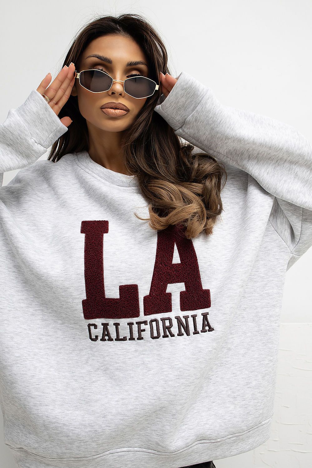 Elegant women’s sweatshirt from Rue Paris, featuring a stylish design with embroidered inscriptions, showcasing the comfort of a cotton blend perfect for everyday wear.