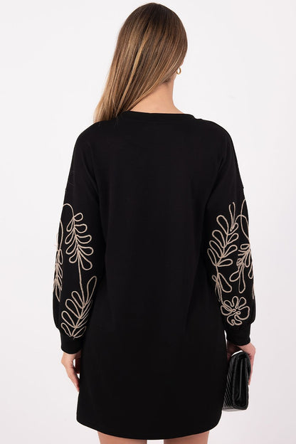 Model wearing Rue Paris elegant casual daydress, featuring puffy sleeves and round neckline, ideal for stylish everyday occasions.