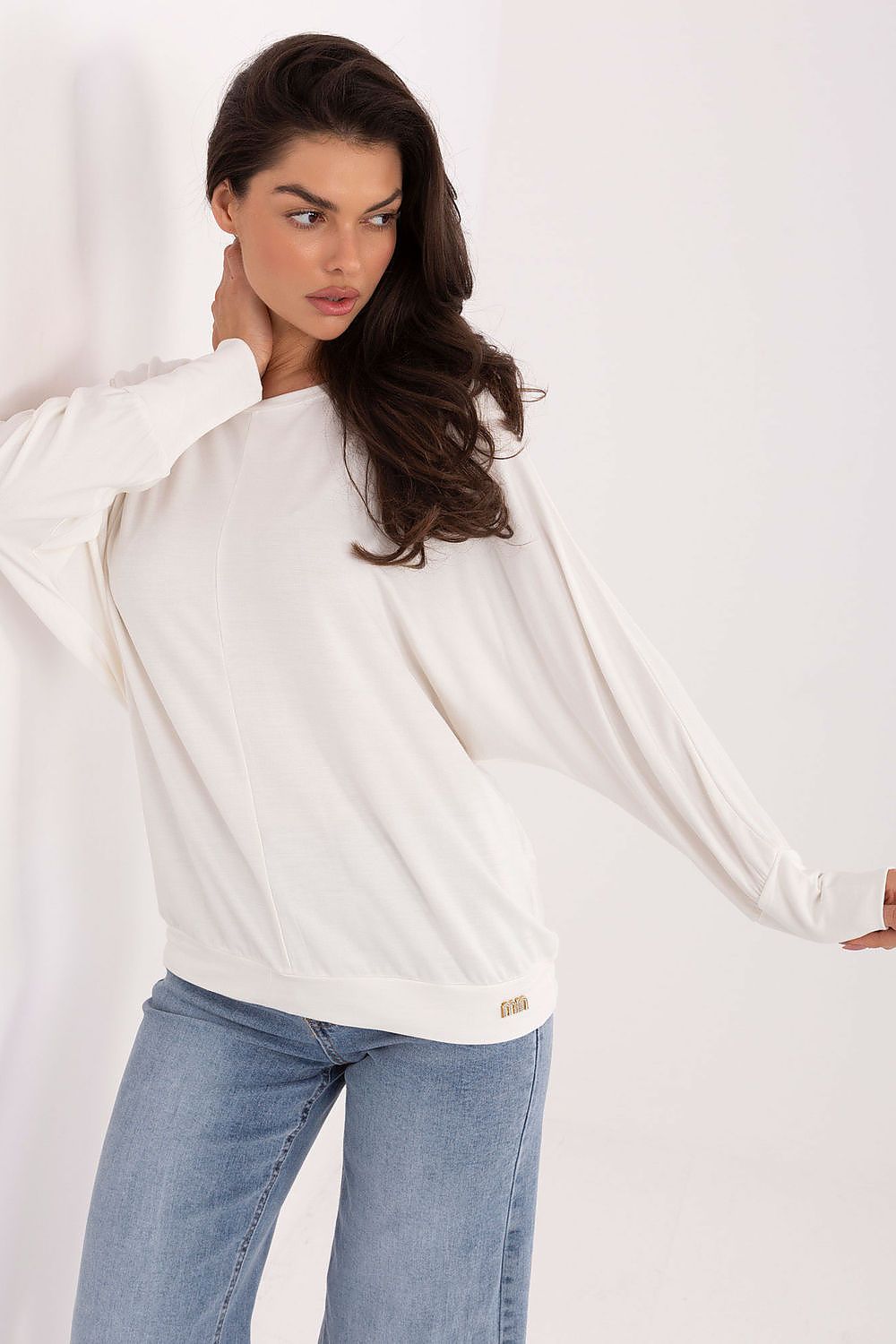 Close-up of Relevance's luxury blouse, showcasing the soft texture and long sleeves in stylish minimalist design.