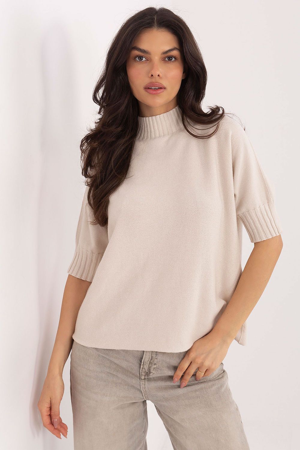Model displaying the sophisticated women's short sleeve sweater with low turtleneck from Italy Moda, perfect for transitional seasons with a minimalist design.
