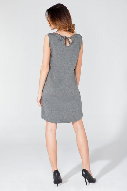 The timeless elegance of Tessita's Knitted Daydress showcasing a delicate teardrop back and bow detail, offered in a range of sizes from S to XXXL.