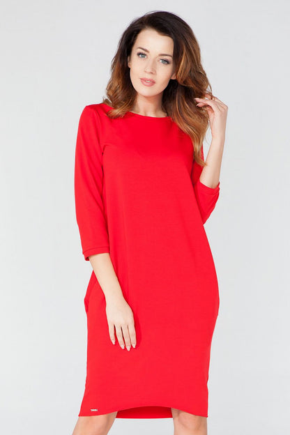 Elegant knitted daydress by Tessita, featuring pockets, 3/4 sleeves, and tuba cut design.