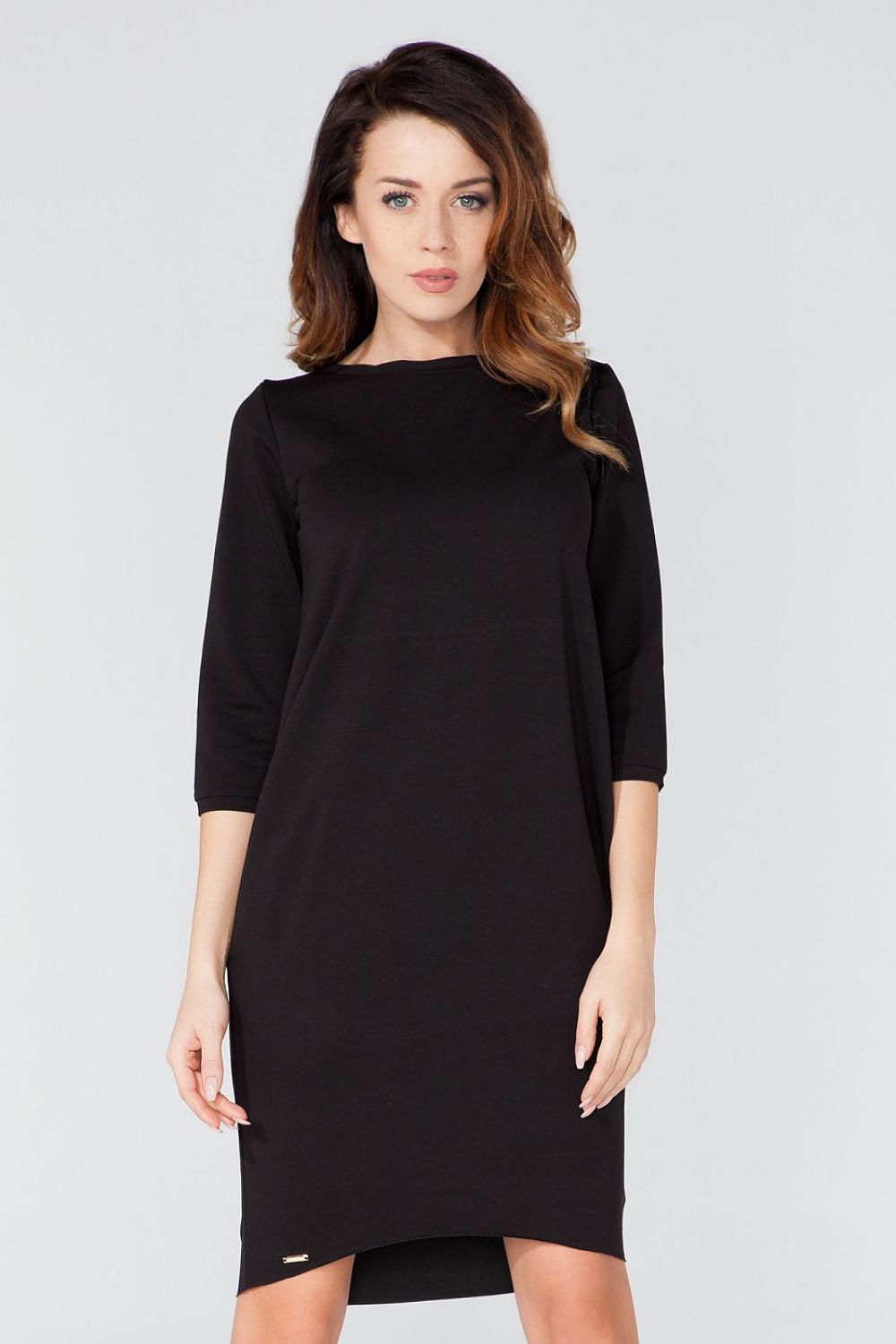Sophisticated knitted daydress with pockets by Tessita, featuring a contemporary tuba cut and 3/4 sleeves.
