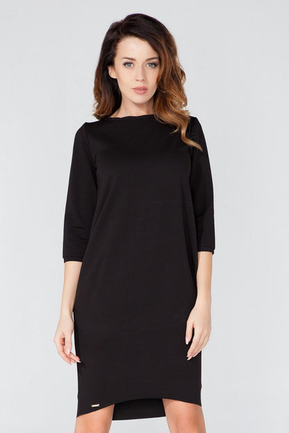 Sophisticated knitted daydress with pockets by Tessita, featuring a contemporary tuba cut and 3/4 sleeves.