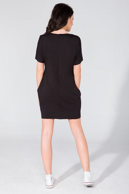 Close-up of the raw neckline and sleeve details of the Tessita Daydress, highlighting its sophisticated design.