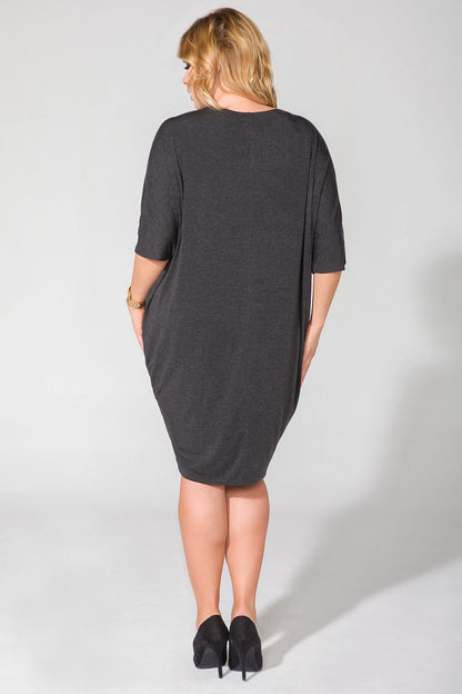 Model wearing Tessita Wide Cut Knit Dress with V-Shaped Neckline and Drape Finish - Luxurious Style, demonstrating its flattering fit and fashionable look.