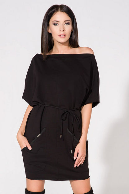 Elegant Tessita loose-fitting knitted daydress with spacious front pockets and a stylish boat neckline, designed for comfort and sophistication.