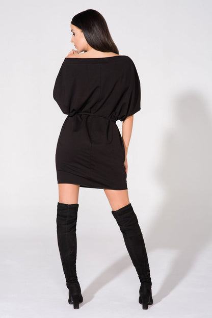 Stylish Tessita loose-fitting knitted daydress in a premium cotton blend, featuring generous front pockets and an elegant boat neckline.