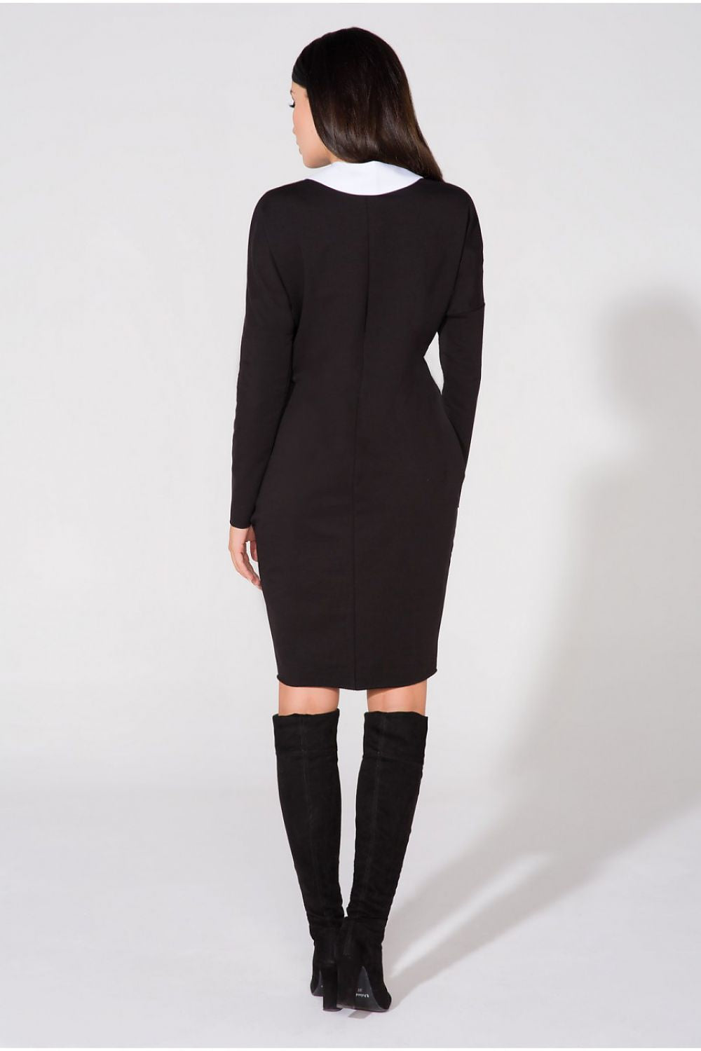 Model wearing the Chic Evening Dress with Pockets and Raw Edge Detail by Tessita, demonstrating the dress's elegance in a luxurious setting.