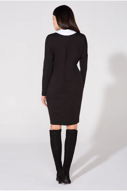 Model wearing the Chic Evening Dress with Pockets and Raw Edge Detail by Tessita, demonstrating the dress's elegance in a luxurious setting.