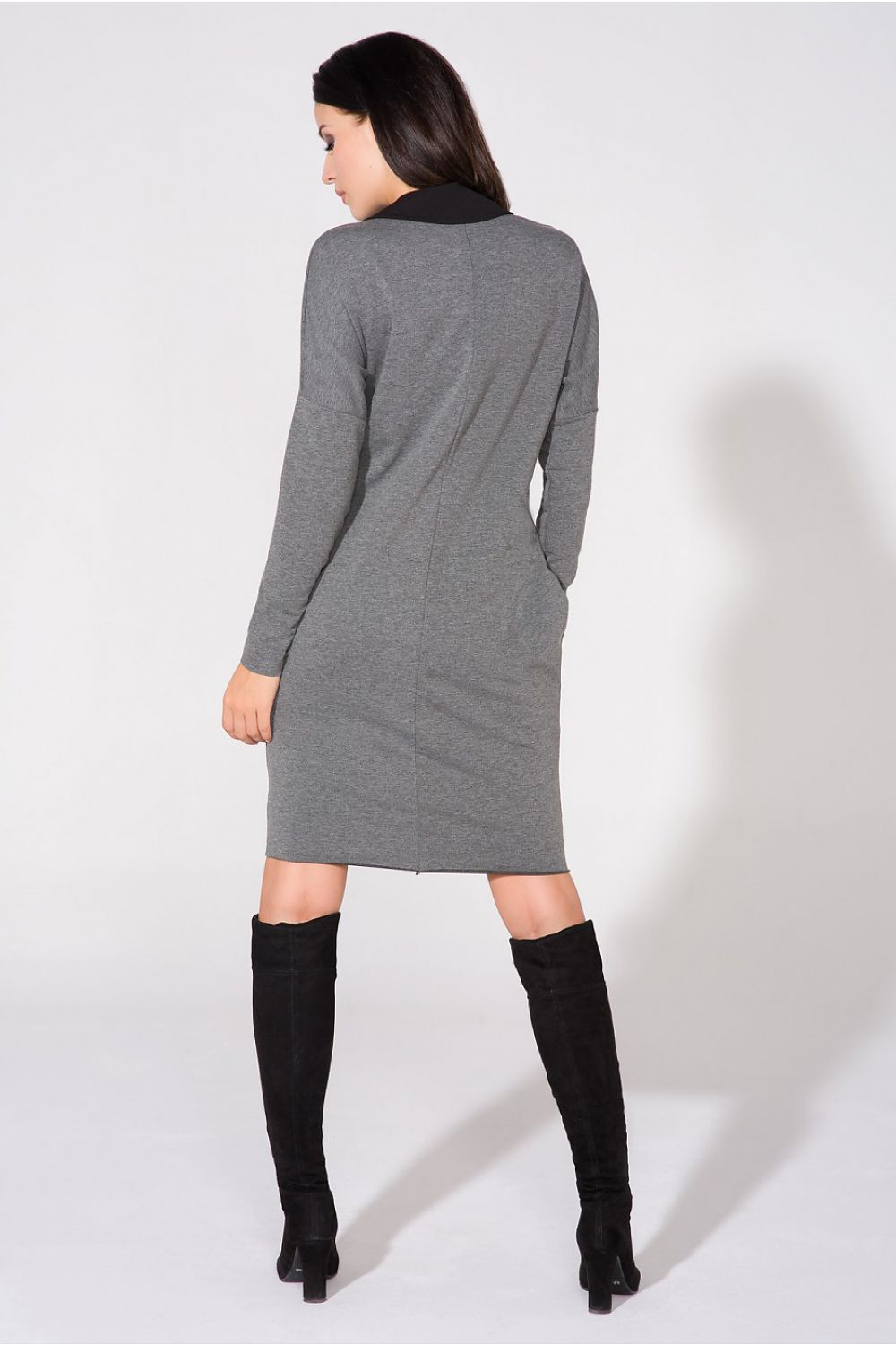 Model wearing the chic evening dress with pockets and raw edge detail by Tessita, exuding elegance and grace.