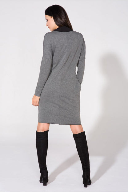 Model wearing the chic evening dress with pockets and raw edge detail by Tessita, exuding elegance and grace.