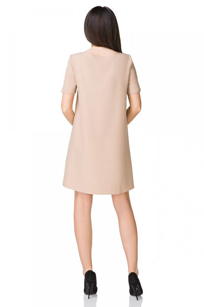 Elegant Tessita Cocktail Dress draped elegantly, featuring its gentle rounded hem that adds grace to summer celebrations.