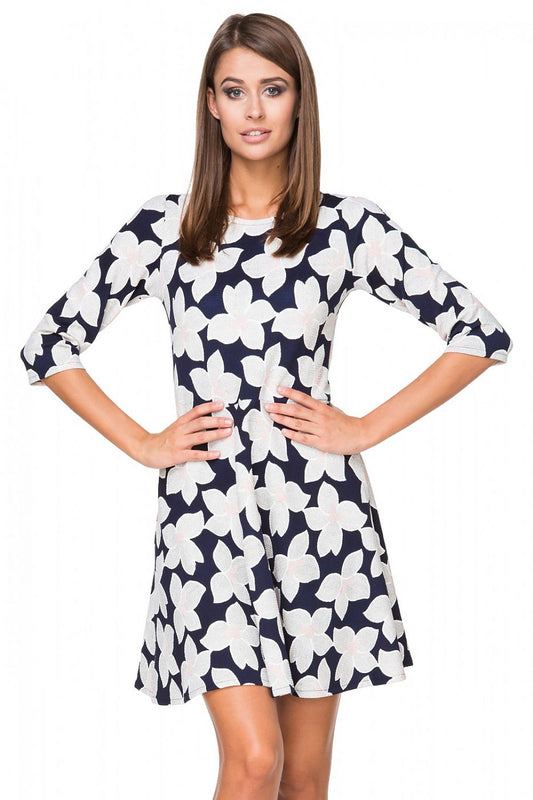 Elegant flared knit dress by Tessita featuring a delicate boat neckline and 3/4 sleeves, perfect for sophisticated occasions.