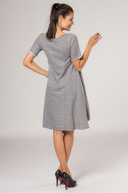 Tessita Grey Quilted Daydress in a sophisticated setting, highlighting its elegant style and flared silhouette.