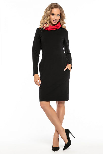 Sophisticated Tessita black sports dress showcasing its unique contrasting colour details in the chimney and pockets, perfect for an active lifestyle.