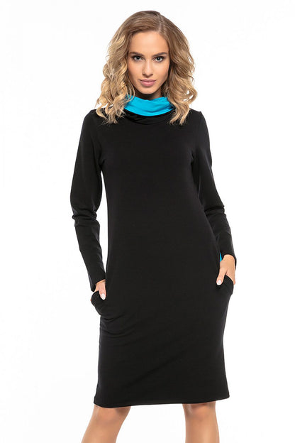 Luxurious black cotton knit sports dress from Tessita showcasing unique contrasting details in the chimney and pockets, perfect for a fashionable yet comfortable look.