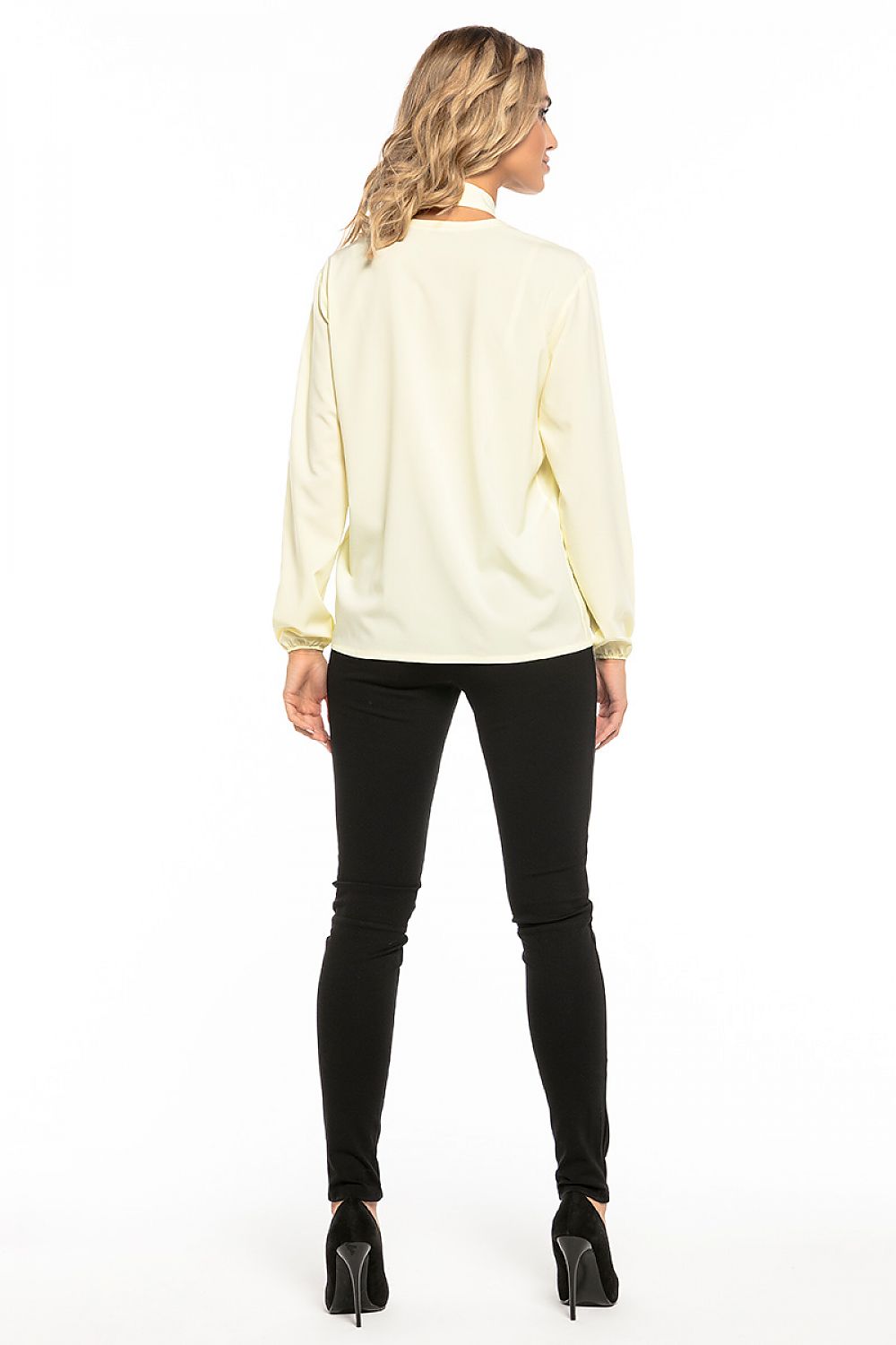 Model wearing Tessita's elegant chiffon blouse with deep neckline, styled for a chic evening look.