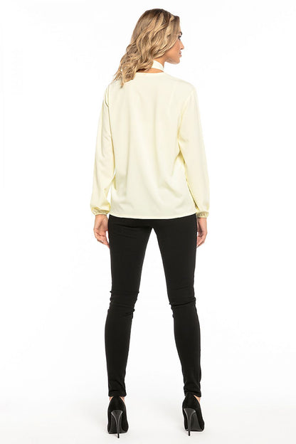 Model wearing Tessita's elegant chiffon blouse with deep neckline, styled for a chic evening look.