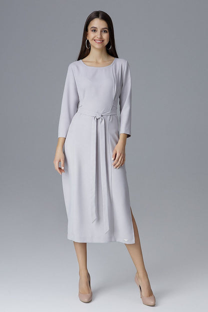 Elegant Figl cocktail dress featuring 3/4 sleeves, waist tie, and sophisticated side slits for a luxurious look.
