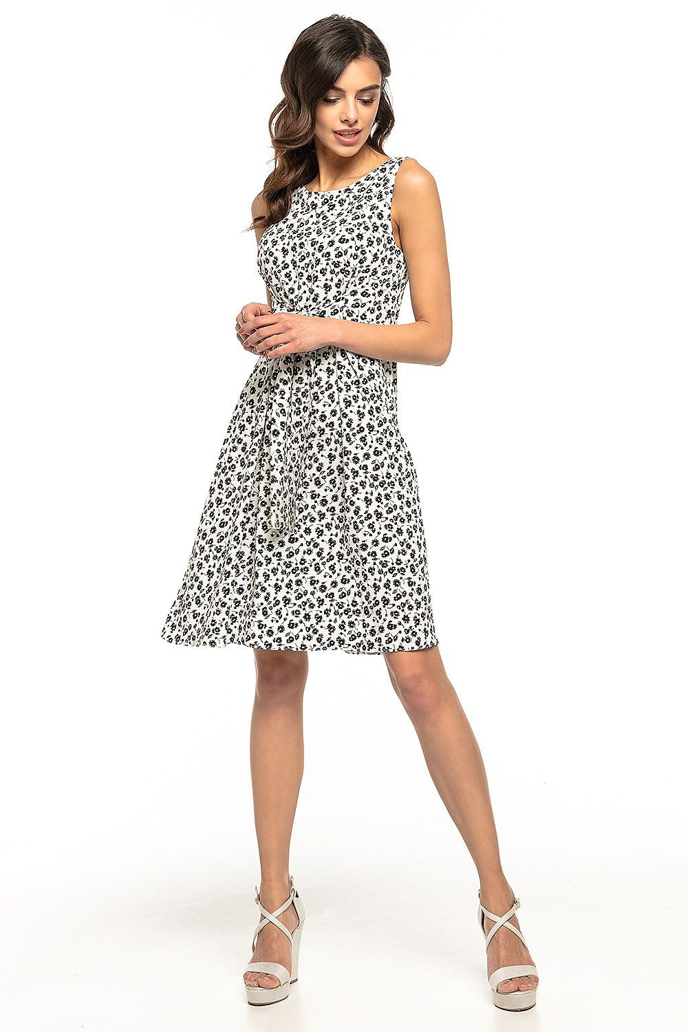 The back of the Elegant Floral Daydress by Tessita, demonstrating its adjustable bow tie feature for a custom fit.