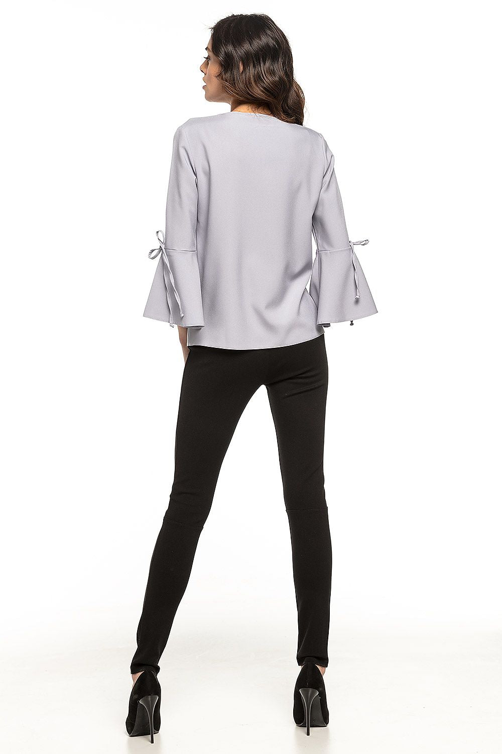 Close-up of the elegant blouse by Tessita, highlighting the soft fabric and delicate frill details that add a luxurious touch to any wardrobe.