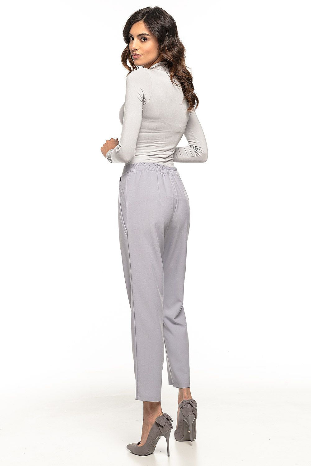 Tessita women's cigarette trousers styled for a chic look, highlighting the tapered leg design and elastic waistband for comfort.