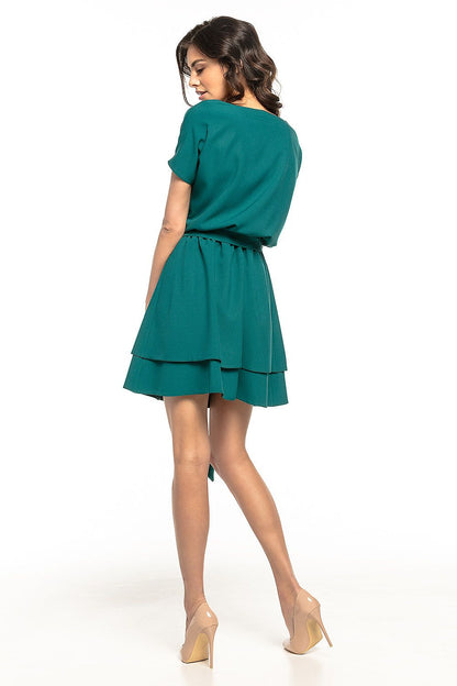 A serene setting featuring the Tessita Daydress draping elegantly, emphasizing its chic design and luxurious quality.