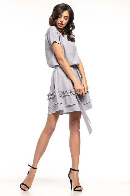 Elegant Tessita daydress featuring a kimono cut and flared skirt, perfect for special occasions.