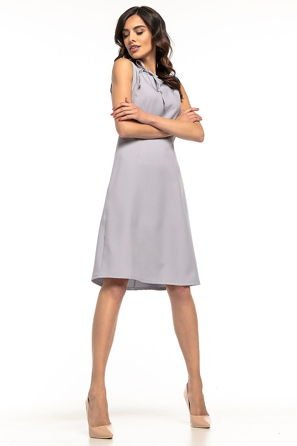 Elegant Tessita Daydress showcased, featuring a trapezoidal hem and decorative tie neckline, perfect for both professional and casual styling. Ideal for ladies who value sophistication.