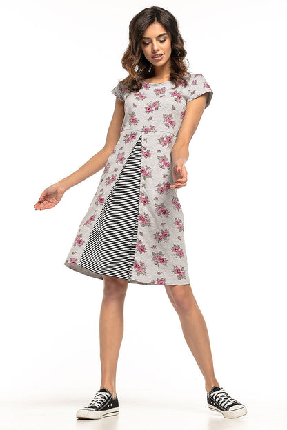 Luxurious shot of Tessita's floral cotton dress showcasing its intricate design and flattering silhouette with striped accents.