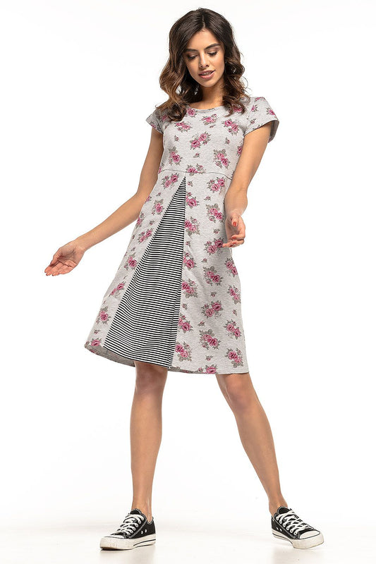 Luxurious shot of Tessita's floral cotton dress showcasing its intricate design and flattering silhouette with striped accents.