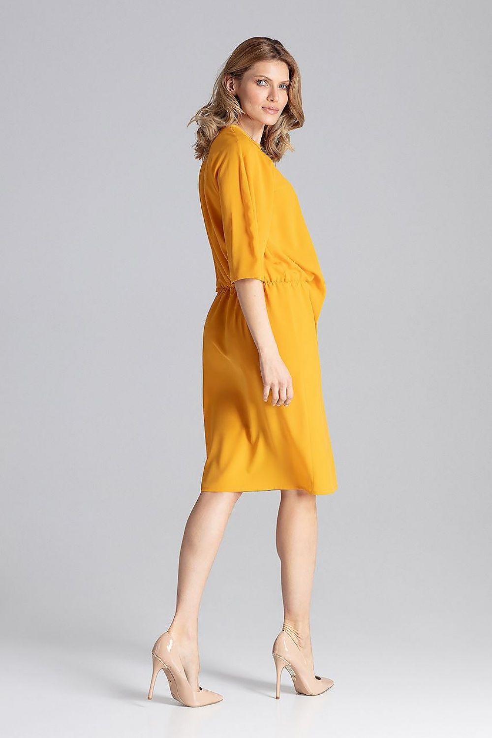 Model wearing the Elegant Knee-Length Daydress by Figl, highlighting its flattering elastic waist and stylish loose reglan sleeves.