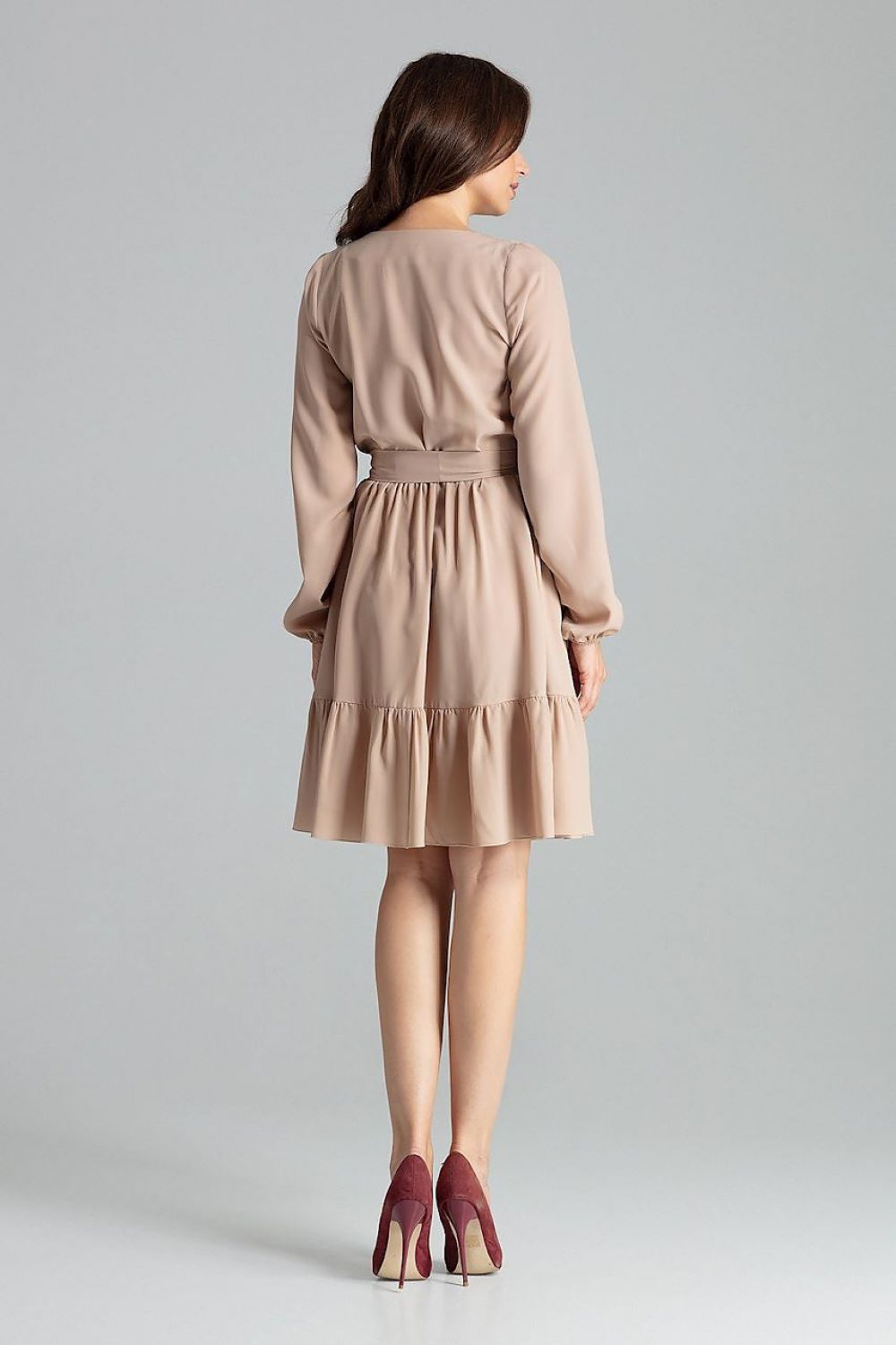 Full-view of the Elegant Beige Midi Dress with Long Sleeves, Ruffle Hem and Sash Tie by Lenitif, worn by a model, demonstrating its exquisite flow and flattering silhouette.