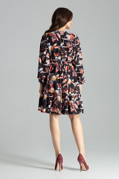 Elegant Beige Midi Dress with Long Sleeves, Ruffle Hem and Sash Tie by Lenitif - Model demonstration of the dress in a chic styling context.